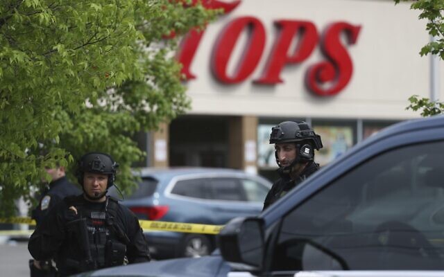 Police secure a perimeter after a shooting at a supermarket, Saturday, May 14, 2022, in Buffalo, NY (AP Photo/Joshua Bessex)
