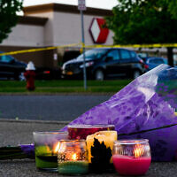 Flowers and candles outside the scene of a shooting at a supermarket, in Buffalo, NY, May 15, 2022. (AP Photo/Matt Rourke)