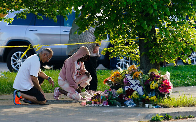 People pay their respects outside the scene of a shooting at a supermarket in Buffalo, N.Y., Sunday, May 15, 2022. (AP Photo/Matt Rourke)