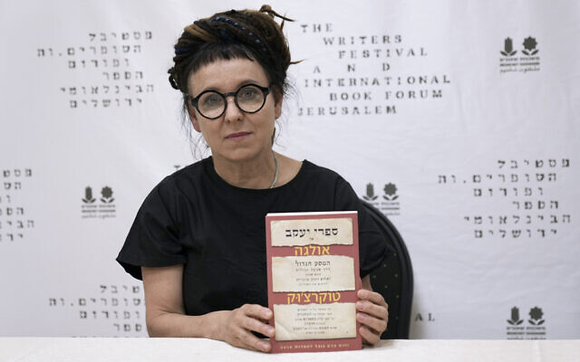 Polish writer and Nobel Prize winner for literature Olga Tokarczuk poses with her book 'The Books of Jacob, during a press conference in Jerusalem, May 15, 2022. (AP Photo/Tsafrir Abayov)
