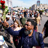 People march to the scene of a shooting at a supermarket in Buffalo, N.Y., Sunday, May 15, 2022. (AP Photo/Matt Rourke)