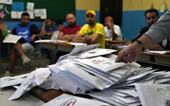 Lebanese election officials count ballots shortly after polling stations closed, in the northern city of Tripoli, Lebanon, May 15, 2022. (AP Photo/Bilal Hussein)