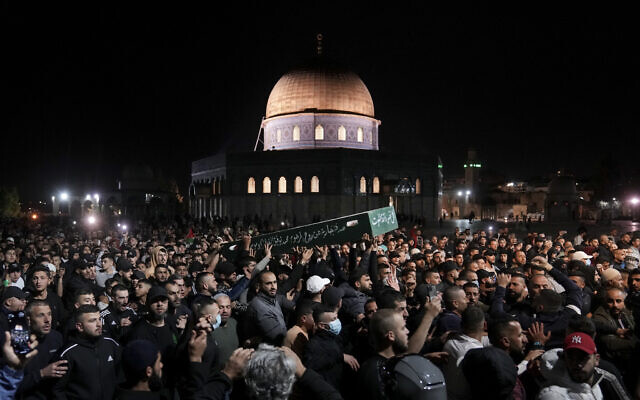 Mourners carry the coffin of Palestinian, Waleed Shareef, 21, during his funeral at the Al Aqsa Mosque compound in Jerusalem's Old City, May 16, 2022. (AP Photo/Mahmoud Illean)