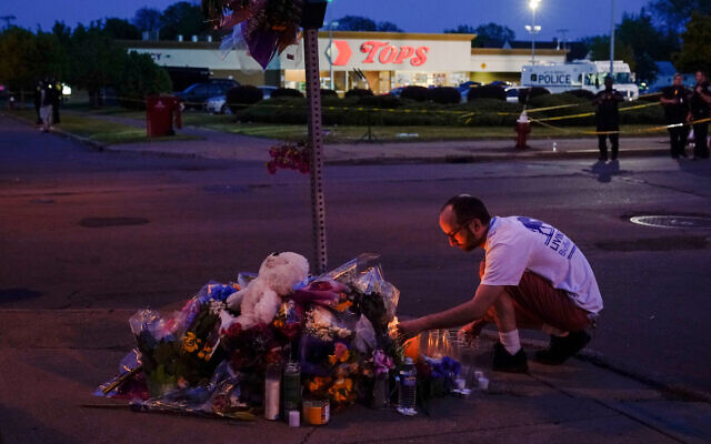 A person pays his respects at a makeshift memorial outside the scene of a shooting at a supermarket in Buffalo, New York, May 15, 2022. (AP/Matt Rourke, File)