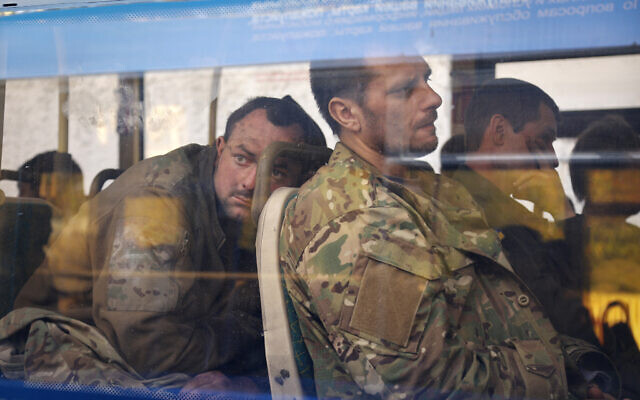 Ukrainian servicemen sit in a bus after they were evacuated from the besieged Mariupol's Azovstal steel plant, near a remand prison in Olyonivka, in territory under the government of the Donetsk People's Republic, eastern Ukraine, May 17, 2022. (Alexei Alexandrov/AP)