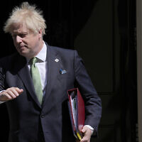 Britain's Prime Minister Boris Johnson leaves 10 Downing Street for the House of Commons for the weekly Prime Minister's Questions In London, May 18, 2022. (AP Photo/Alastair Grant)