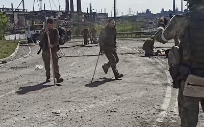 Ukrainian servicemen as they leave the besieged Azovstal steel plant in Mariupol, Ukraine, on May 18, 2022. (from a video released by Russian Defense Ministry Press Service via AP)