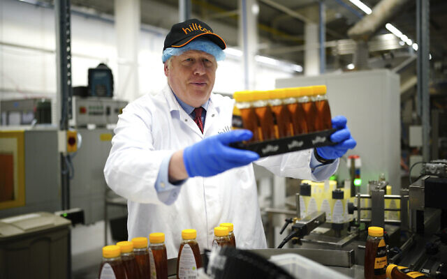 British Prime Minister Boris Johnson during a visit to Hilltop Honey in Newtown, Powys, Wales, May 20, 2022.  (Ben Birchall/Pool via AP)