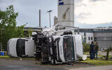 Two trucks overturned after a storm in Paderborn, Germany, May 20, 2022  (Lino Mirgeler/dpa via AP)