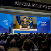 Ukrainian President Volodymyr Zelensky displayed on a screen as he addresses the audience from Kyiv on a screen during the World Economic Forum in Davos, Switzerland, May 23, 2022. (Markus Schreiber/AP)