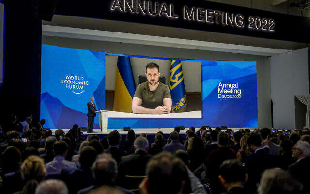 Ukrainian President Volodymyr Zelensky displayed on a screen as he addresses the audience from Kyiv on a screen during the World Economic Forum in Davos, Switzerland, May 23, 2022. (Markus Schreiber/AP)