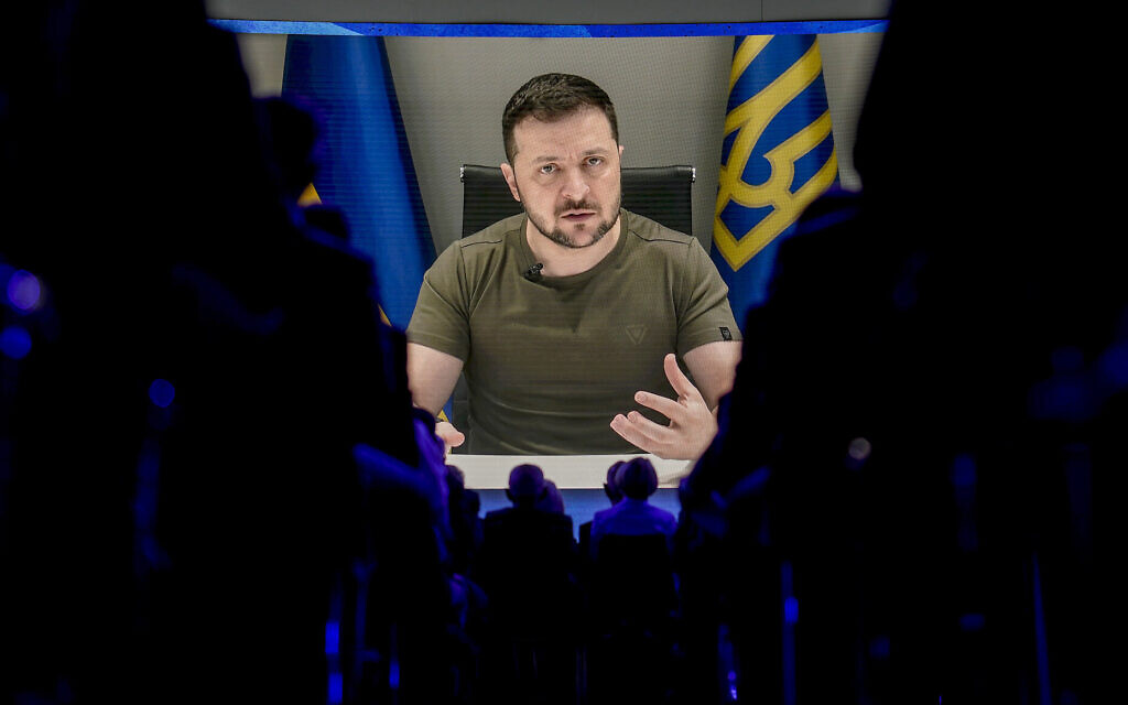 Ukrainian President Volodymyr Zelensky is seen on a screen as he addresses the audience from Kyiv during the World Economic Forum in Davos, Switzerland, May 23, 2022. (AP/Markus Schreiber, File)