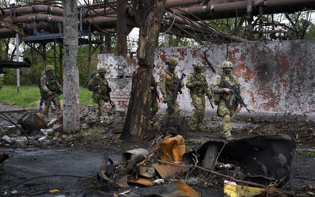 Russian troops walk in a destroyed part of the Illich Iron & Steel Works Metallurgical Plant in Mariupol, in territory under the government of the Donetsk People's Republic, eastern Ukraine, May 18, 2022. (AP Photo, File)
