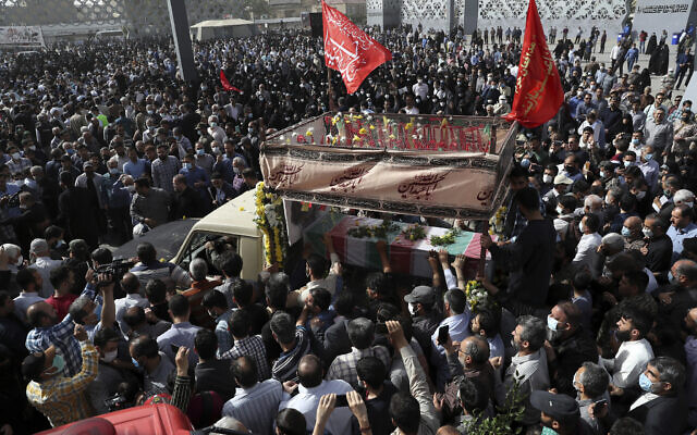 Mourners gather around a truck carrying the flag draped coffin of Iran's Revolutionary Guard Col. Hassan Sayyad Khodaei who was killed on Sunday, in his funeral ceremony in Tehran, Iran, May 24, 2022. (AP Photo/Vahid Salemi)