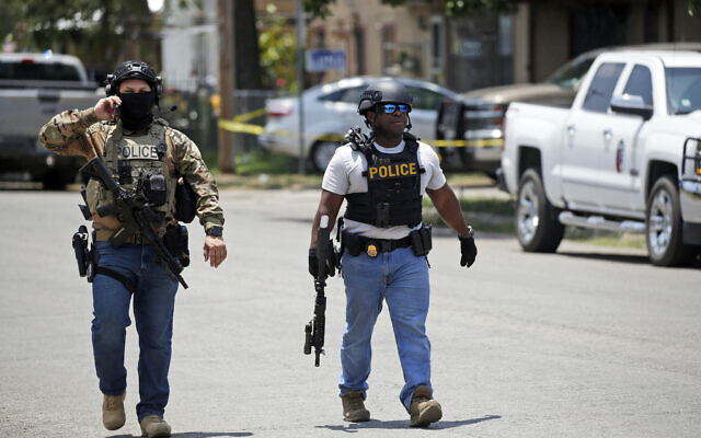 Police walk near Robb Elementary School following a shooting, Tuesday, May 24, 2022, in Uvalde, Texas. (AP Photo/Dario Lopez-Mills)