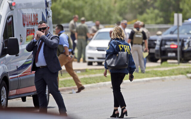 Law enforcement personnel, including the FBI, gather near Robb Elementary School following a shooting, Tuesday, May 24, 2022, in Uvalde, Texas. (AP Photo/Dario Lopez-Mills)