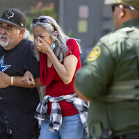A woman cries as she leaves the Uvalde Civic Center, May 24, 2022, in Uvalde, Texas, following a deadly school shooting in the town. (William Luther/The San Antonio Express-News via AP)