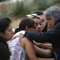 The archbishop of San Antonio, Gustavo Garcia-Siller, comforts families outside the Civic Center following a deadly school shooting at Robb Elementary School in Uvalde, Texas, May 24, 2022. (AP Photo/Dario Lopez-Mills)