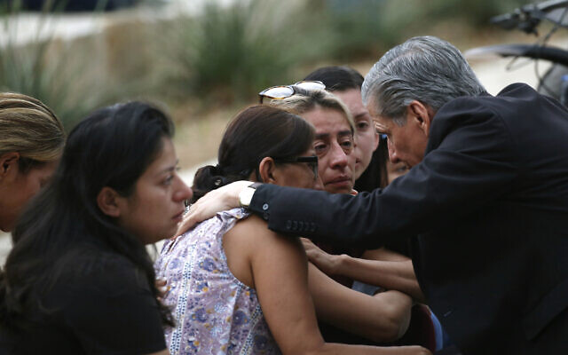 The archbishop of San Antonio, Gustavo Garcia-Siller, comforts families outside the Civic Center following a deadly school shooting at Robb Elementary School in Uvalde, Texas, May 24, 2022. (AP Photo/Dario Lopez-Mills)