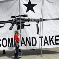 A demonstrator helps hold a large "Come and Take It" banner at a rally in support of open carry gun laws at the Capitol, on Jan. 26, 2015, in Austin, Texas. A gunman killing multiple elementary school children and adults in Texas on May 24, 2022, adds to the state's grim recent history of mass shootings. (AP Photo/Eric Gay, File)