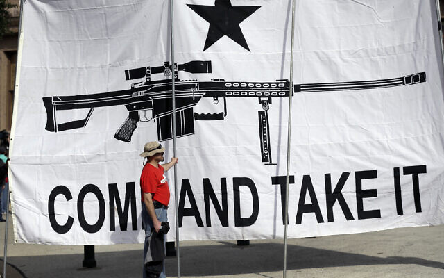 A demonstrator helps hold a large "Come and Take It" banner at a rally in support of open carry gun laws at the Capitol, on Jan. 26, 2015, in Austin, Texas. (AP/Eric Gay)