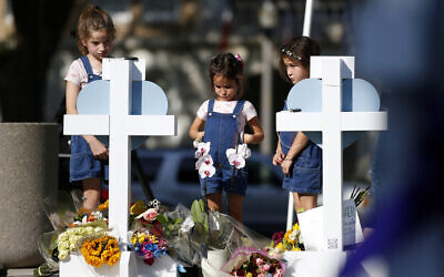 Children pay their respects at a memorial site for the victims killed in this week's elementary school shooting in Uvalde, Texas, Thursday, May 26, 2022. (AP Photo/Dario Lopez-Mills)