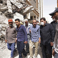 Iranian Senior Vice-President Mohammad Mokhber (second right) visits the 10-story Metropol Building which collapsed on Monday, in the city of Abadan, Iran, May 27, 2022. (Iranian Senior Vice-President Office via AP)