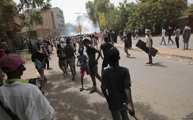 Protesters clash with security forces as they fire teargas to prevent them from marching towards the presidential palace during demonstrations demanding civilian rule, in Khartoum, Sudan, May 19, 2022.  (AP Photo/Marwan Ali, File)