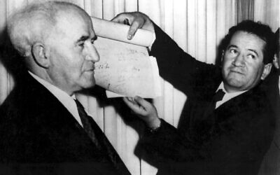 An official shows the signed document which proclaims the establishment of the new Jewish state of Israel declared by prime minister David Ben-Gurion, left, in Tel Aviv at midnight on May 14, 1948. (AP Photo)