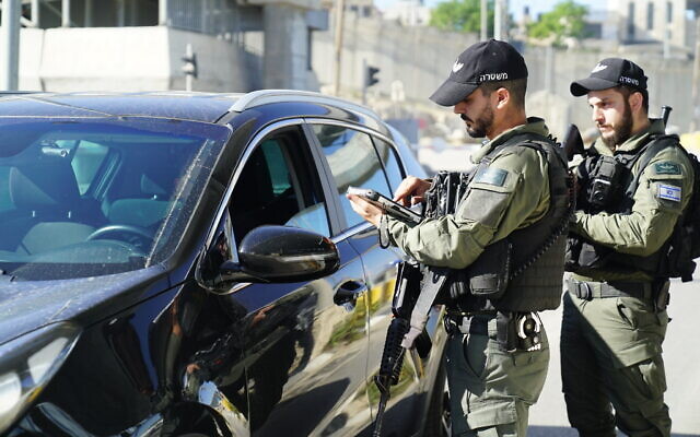 Police check a vehicle to ensure that it is not ferrying illegal Palestinian workers on May 7, 2022. (Israel Police)