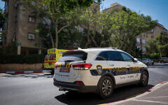 Illustrative: A police car and ambulance in Petah Tikva, August 4, 2017. (Roy Alima/Flash90)