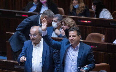 Ahmad Tibi and Ayman Odeh of the Arab Joint List during a plenum session in the assembly hall of the Israeli parliament, in Jerusalem, on July 6, 2021. (Yonatan Sindel/Flash90)