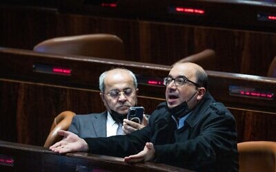 Joint List MKד Sami Abou Shahadeh and Ahmad Tibi seen during a plenum session at the Knesset onFebruary 23, 2022. (Yonatan Sindel/Flash90)