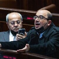 Joint List MKs Sami Abou Shahadeh (right) and Ahmad Tibi seen during a plenum session at the Knesset on February 23, 2022. (Yonatan Sindel/Flash90)