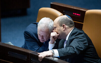 File: Prime Minister Naftali Bennett, right, with Minister of Defense Benny Gantz during a plenum session at the Knesset, on February 28, 2022. (Yonatan Sindel/Flash90)