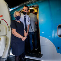 Crew members wearing masks stand at the door for the first direct flight between Tel Aviv and Egypt's Red Sea resort of Sharm el-Sheikh, at Ben Gurion Airport, near Tel Aviv, on April 17, 2022. (Flash90)