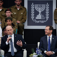 Prime Minister Naftali Bennett (L) and President Isaac Herzog and Prime Minister Naftali Bennett attend an event for outstanding soldiers, as part of Israel's 74th Independence Day celebrations, at the President's Residence in Jerusalem, on May 5, 2022. (Yonatan Sindel/Flash90)