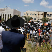 Ultra-Orthodox Jews attend funeral service in Elad for Yonatan Havakuk and Boaz Gol, killed the night before in a terrorist ax attack, on May 6, 2022. (Olivier Fitoussi/Flash90)