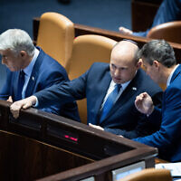 Israeli Prime Minister Naftali Bennett, center, and Foreign Minister Yair Lapid, left, in the Knesset on May 9, 2022. (Yonatan Sindel/Flash90)