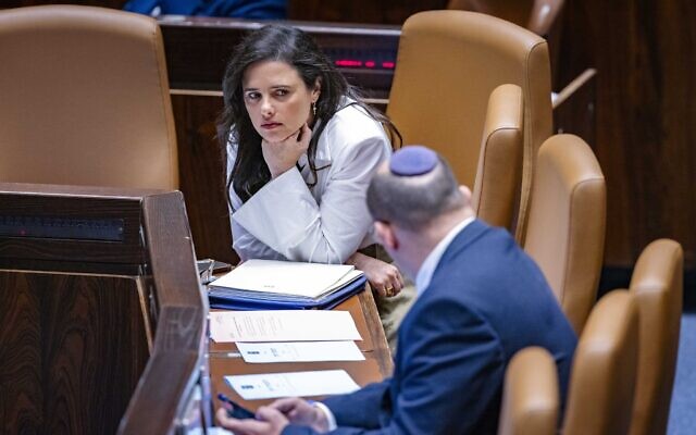 Interior Minister Ayelet Shaked speaks with former Prime Minister Naftali Bennett during a Knesset plenum session, May 11, 2022. (Olivier Fitoussi/Flash90)