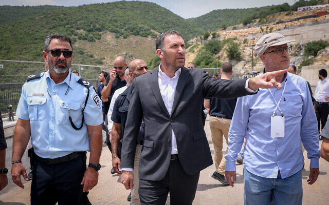 Northern District Police chief Shimon Lavi, left, and Deputy Minister of Religious Affairs Matan Kahana, center, during a tour at the Tomb of Rabbi Shimon bar Yochai, in Meron, northern Israel, May 16, 2022, ahead of the Lag B'omer festival. (David Cohen/Flash90)
