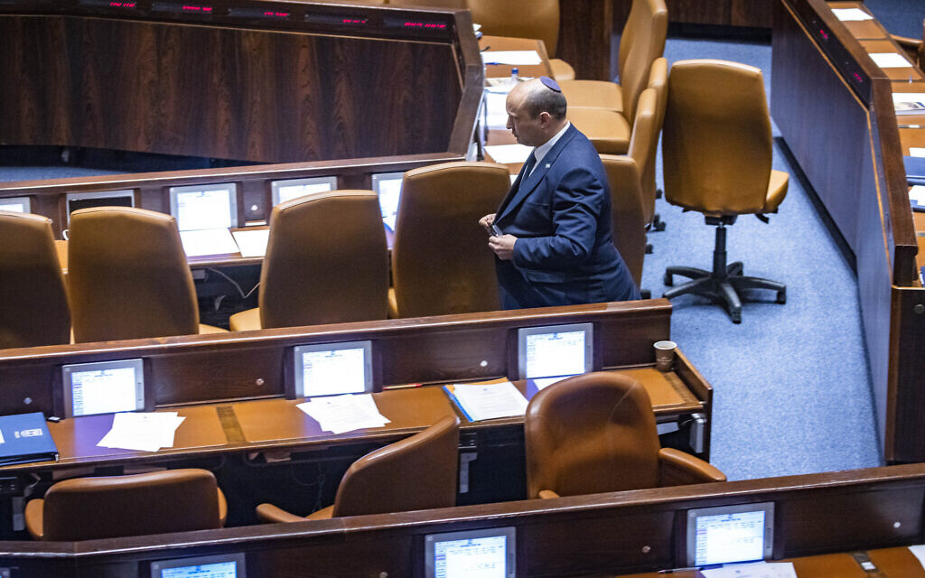 Naftali Bennett walks in the Knesset on May 16, 2022. (Olivier Fitoussi/FLASH90)
