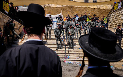 Ultra-Orthodox pilgrims face off with police during Lag B'Omer celebrations, in Meron, on May 19, 2022. (David Cohen/Flash90)