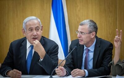 Likud party head Benjamin Netanyahu (L) and faction chair Yariv Levin (R) lead their party's faction meeting at the Knesset, May 23, 2022. (Yonatan Sindel/Flash90)