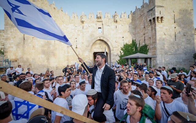 Head of the Religious Zionist Party MK Bezalel Smotrich waves an Israeli flag at Damascus Gate outside Jerusalem’s Old City, during Jerusalem Day celebrations, May 29, 2022. (Olivier Fitoussi/Flash90)