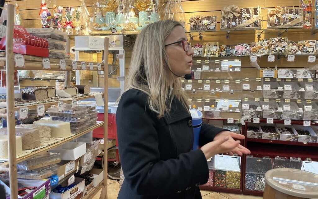 Frieda Vizel speaks to tour-takers in the Chocolicious shop in Williamsburg, New York, April 2022. (Danielle Ziri)