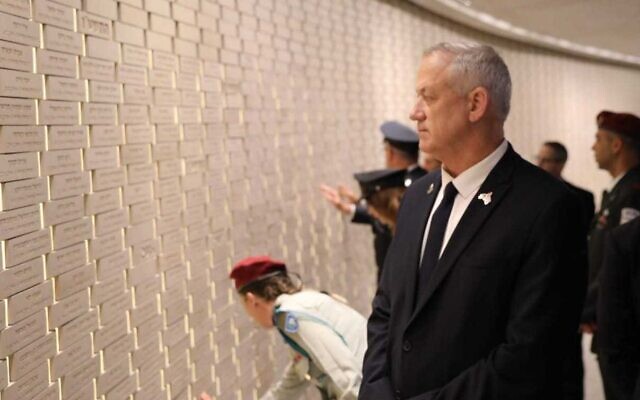 Defense Minister Benny Gantz looks at the names of fallen soldiers in the hall of remembrance at Mount Herzl military cemetery in Jerusalem, during a Memorial Day ceremony on May 4, 2022. (Elad Malka/Defense Ministry)