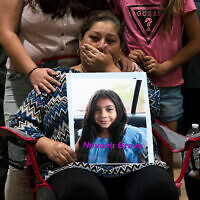 Esmeralda Bravo, 63, sheds tears while holding a photo of her granddaughter, Nevaeh, one of the Robb Elementary School shooting victims, during a prayer vigil in Uvalde, Texas, May 25, 2022. (AP Photo/Jae C. Hong)
