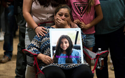 Esmeralda Bravo, 63, sheds tears while holding a photo of her granddaughter, Nevaeh, one of the Robb Elementary School shooting victims, during a prayer vigil in Uvalde, Texas, May 25, 2022. (AP Photo/Jae C. Hong)