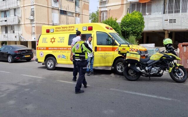 Magen David Adom paramedics are seen outside an apartment in Ashdod where a woman was found dead in a suspected murder, May 16, 2022. (Magen David Adom)